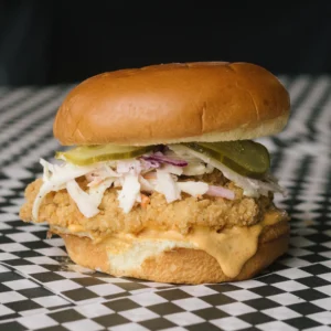 a classic chicken sandwich on a black and white checkered surface