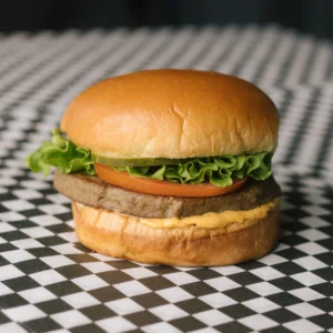 an impossible burger on a black and white checkered surface