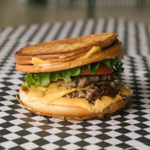 an interrogator burger on a black and white checkered surface
