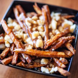 a bowl of poutine on a table