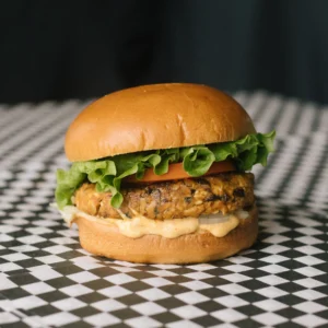 a puritan burger on a black and white checkered surface
