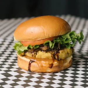a reformer burger on a black and white checkered surface