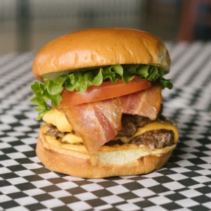 a zealot burger on a black and white checkered surface